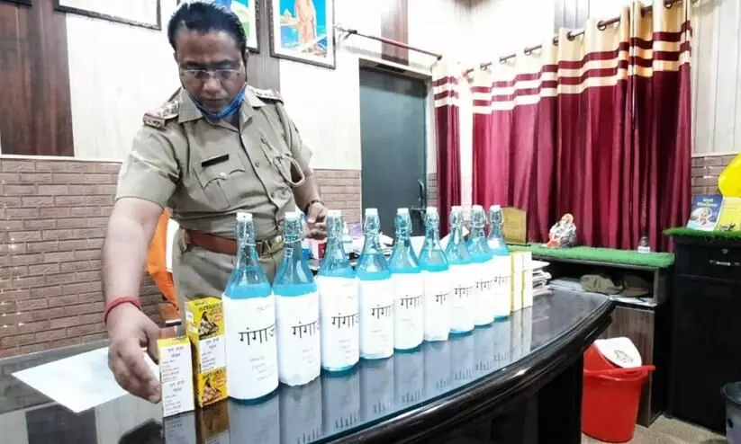UP cop purifies visitors at police station with gangajal Chants sanitisation mantra