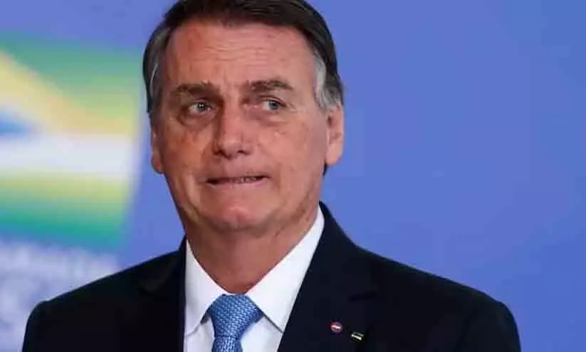 Brazils President Jair Bolsonaro looks on during a promotion