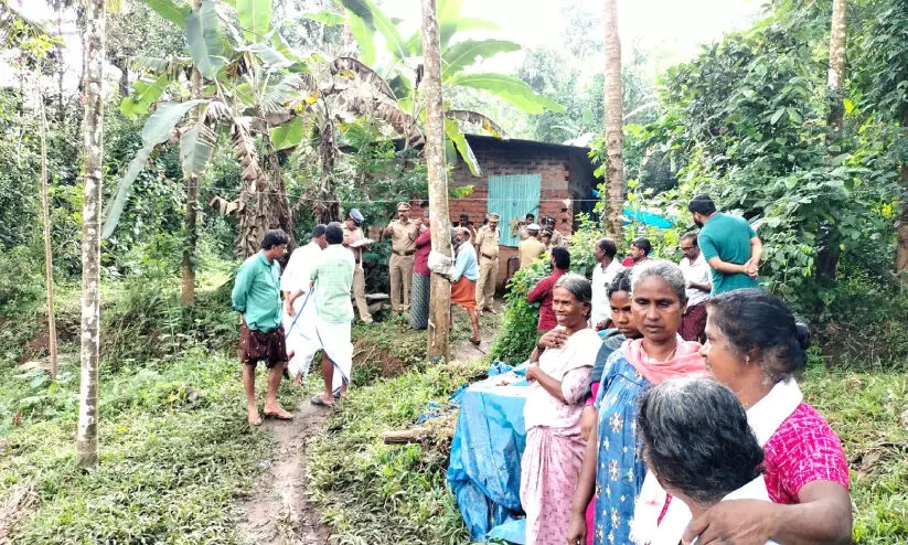 People gathered in front of the house where the murder took place