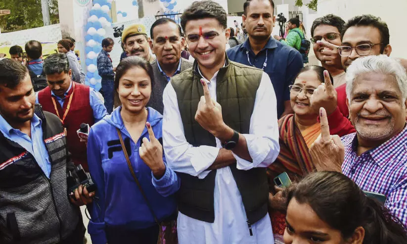 Jaipur leader Sachin Pilot holds up the ink mark as he cast his vote